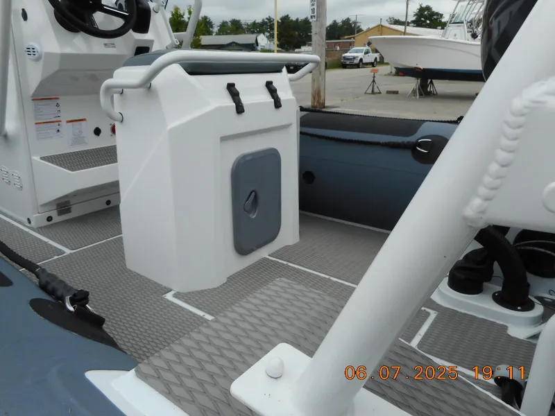 Slide: The Image of 2025 Highfield Patrol 540 boat interior with seating and storage compartment. - 6