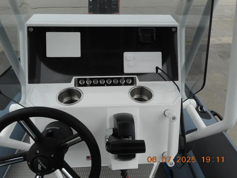Slide: The Image of Highfield Patrol 540 boat dashboard with steering wheel and controls, 2025 model. - 7