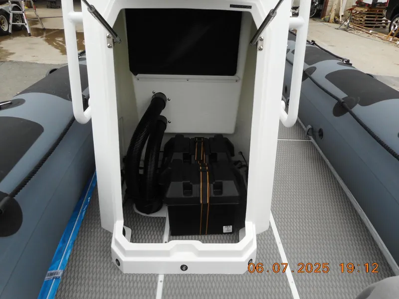 Slide: The Image of 2025 Highfield Patrol 540 boat interior showing storage compartment and equipment. - 9