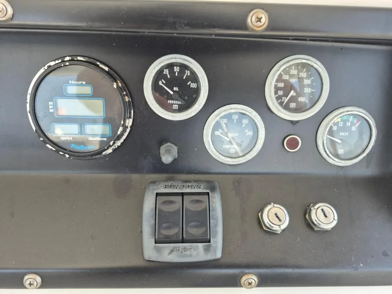 Slide: The Image of Instrument panel of a 1982 Bertram 38 Convertible boat with gauges and switches. - 31