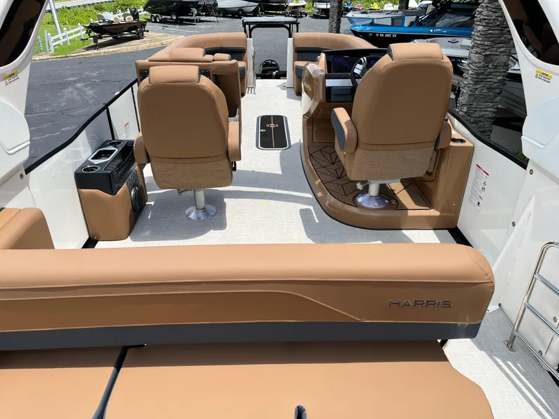Slide: The Image of 2026 Harris Grand Mariner 250 interior with tan seating and modern dashboard. - 17