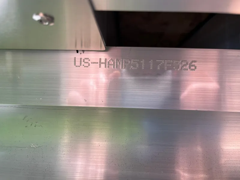 Slide: The Image of 2026 Harris Grand Mariner 250 hull identification number engraved on metal surface. - 23