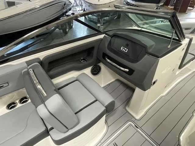 Slide: The Image of 2025 Chaparral 247 SSX boat interior with gray seating and cup holders. - 7