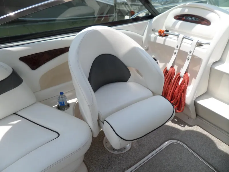 Slide: The Image of Interior of 2005 Sea Ray 290 SS boat with white seating and red ropes. - 10