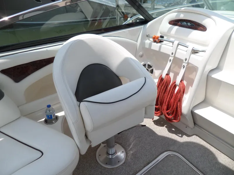 Slide: The Image of Interior of a 2005 Sea Ray 290 SS boat with white seating and red ropes. - 11