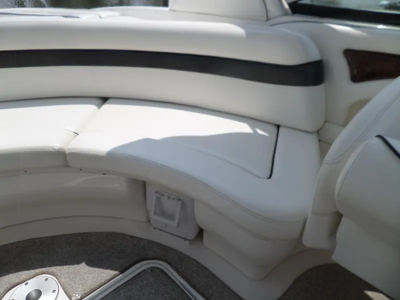 Slide: The Image of 2005 Sea Ray 290 SS boat interior with white cushioned seating. - 12