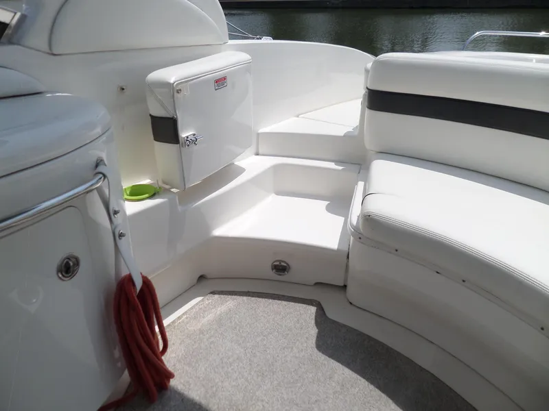 Slide: The Image of 2005 Sea Ray 290 SS boat interior with white seating and storage compartments. - 15