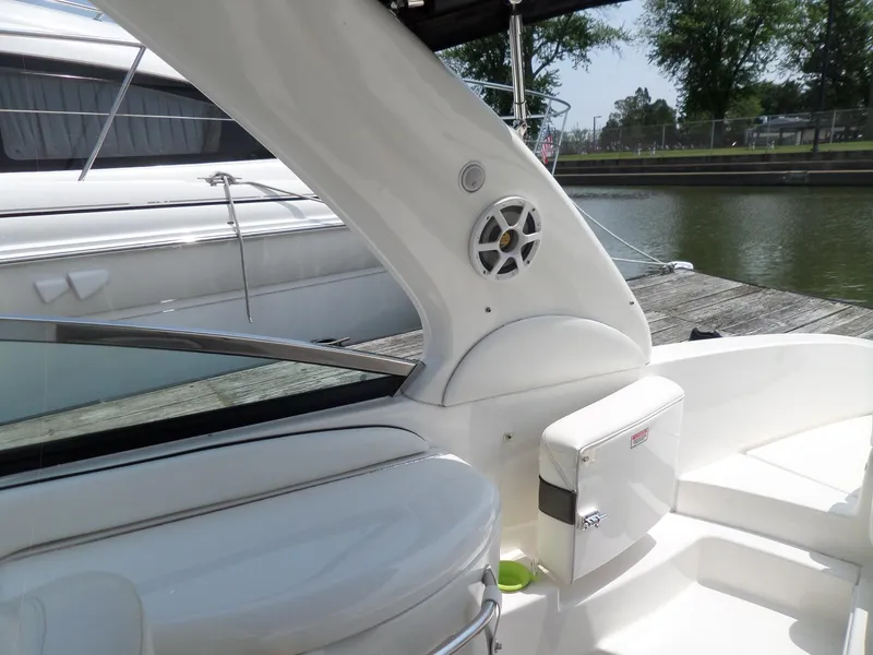 Slide: The Image of 2005 Sea Ray 290 SS boat interior with speaker, docked by the water. - 16