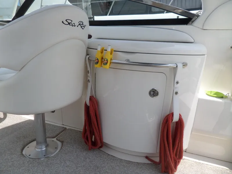Slide: The Image of 2005 Sea Ray 290 SS boat interior with white seating and red ropes. - 17
