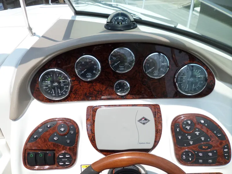 Slide: The Image of Dashboard of a 2005 Sea Ray 290 SS boat with gauges and controls. - 19
