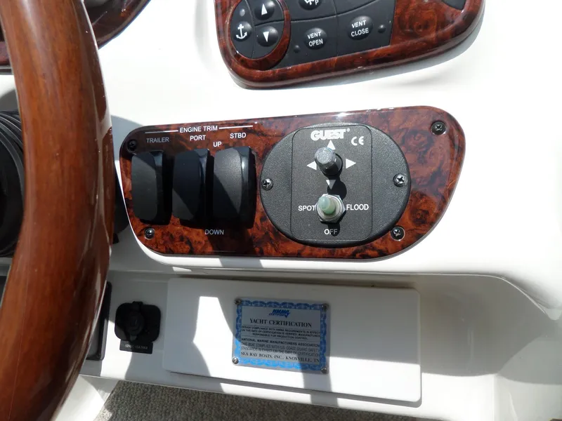 Slide: The Image of Control panel of a 2005 Sea Ray 290 SS boat with wood trim and switches. - 23