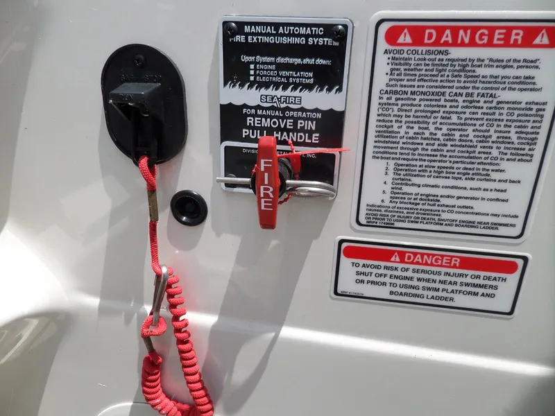 Slide: The Image of 2005 Sea Ray 290 SS fire extinguisher system with safety warnings and instructions. - 26