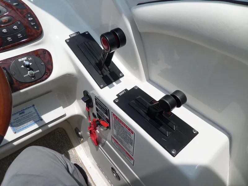 Slide: The Image of Throttle controls on a 2005 Sea Ray 290 SS boat dashboard. - 27