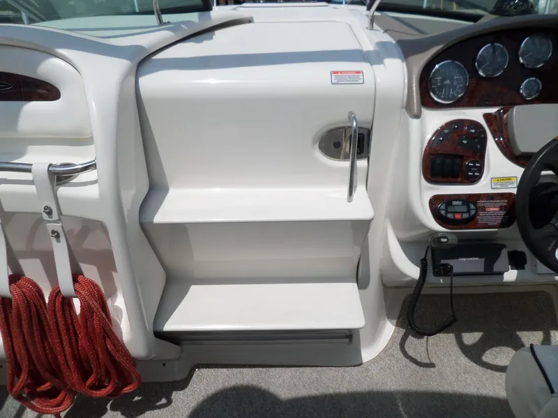 Slide: The Image of 2005 Sea Ray 290 SS boat dashboard with steps and red ropes. - 30