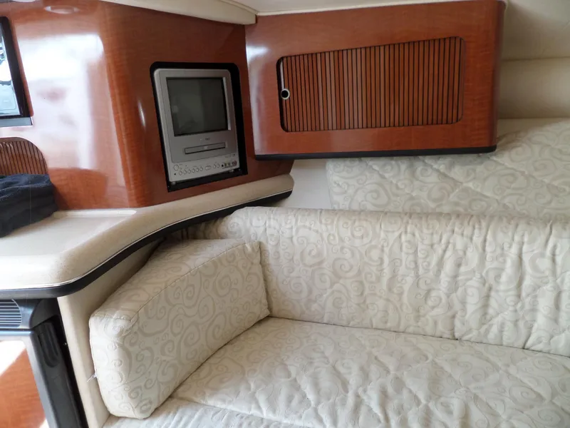 Slide: The Image of Interior of 2005 Sea Ray 290 SS with TV and cushioned seating. - 33