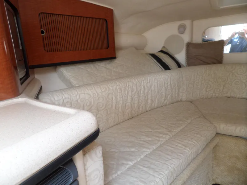 Slide: The Image of Interior of 2005 Sea Ray 290 SS boat with elegant seating and wood accents. - 34