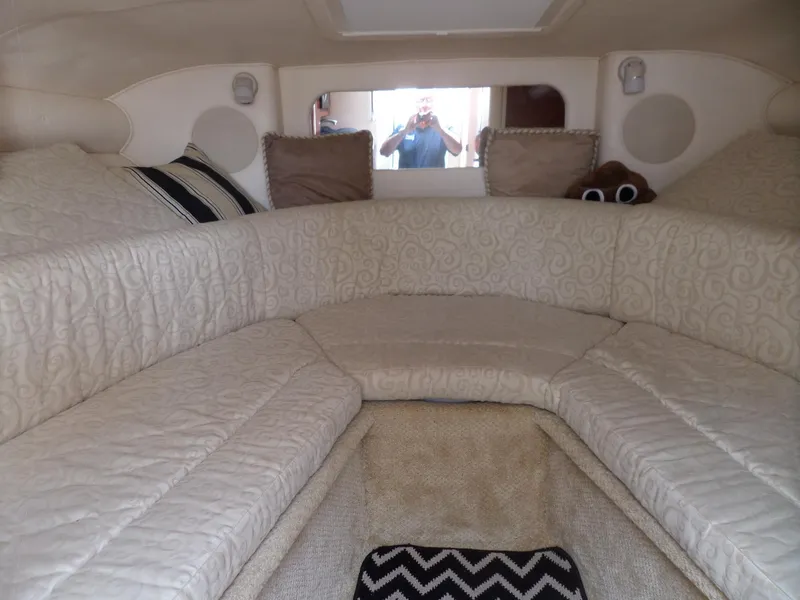 Slide: The Image of Interior cabin of 2005 Sea Ray 290 SS boat with beige upholstery and cushions. - 35