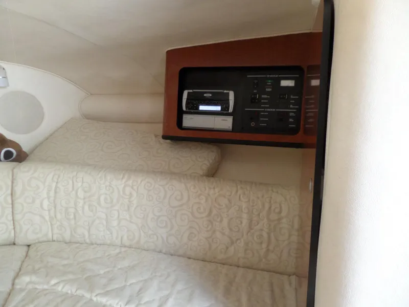 Slide: The Image of Interior cabin of 2005 Sea Ray 290 SS with control panel and cushioned seating. - 36