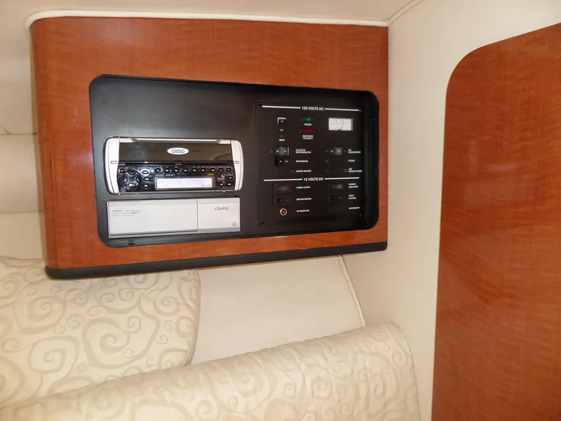Slide: The Image of 2005 Sea Ray 290 SS cabin control panel with audio system and wood finish. - 37