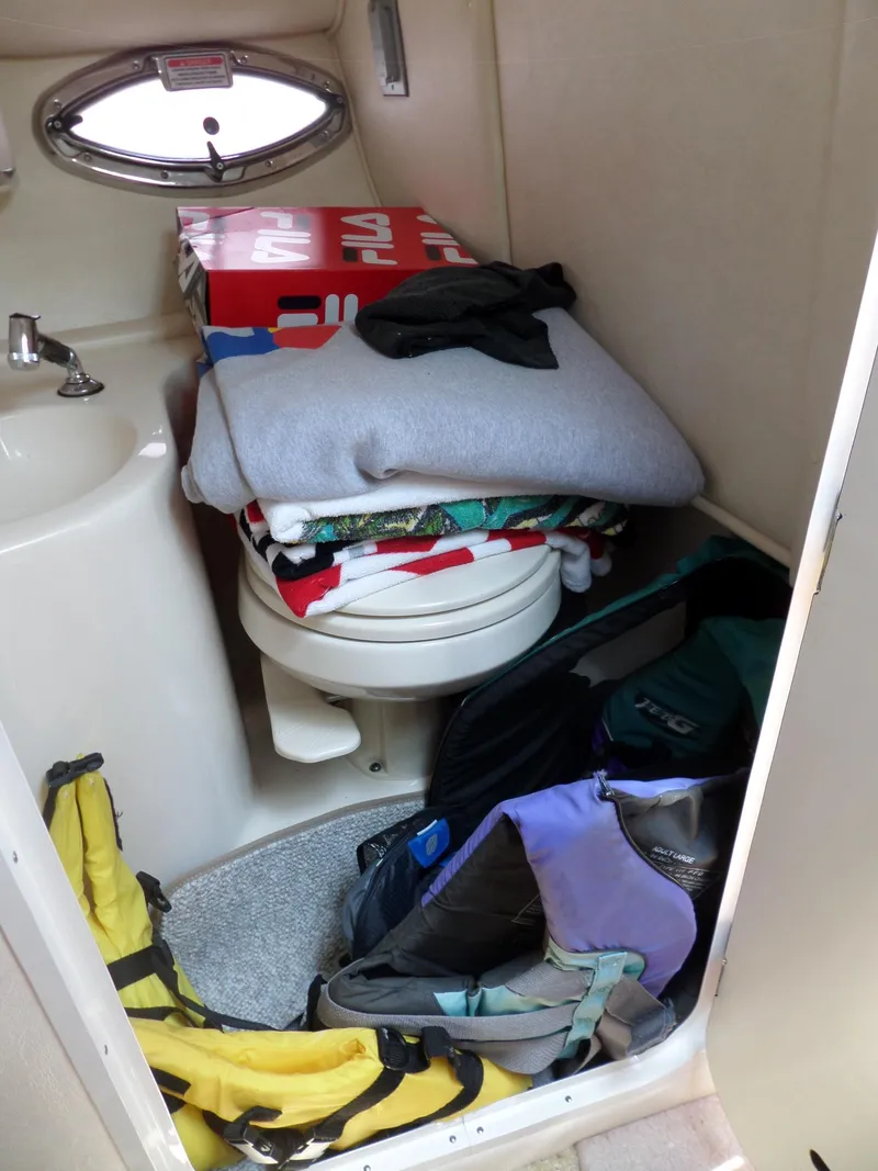 Slide: The Image of 2005 Sea Ray 290 SS cabin with storage items and backpacks. - 39