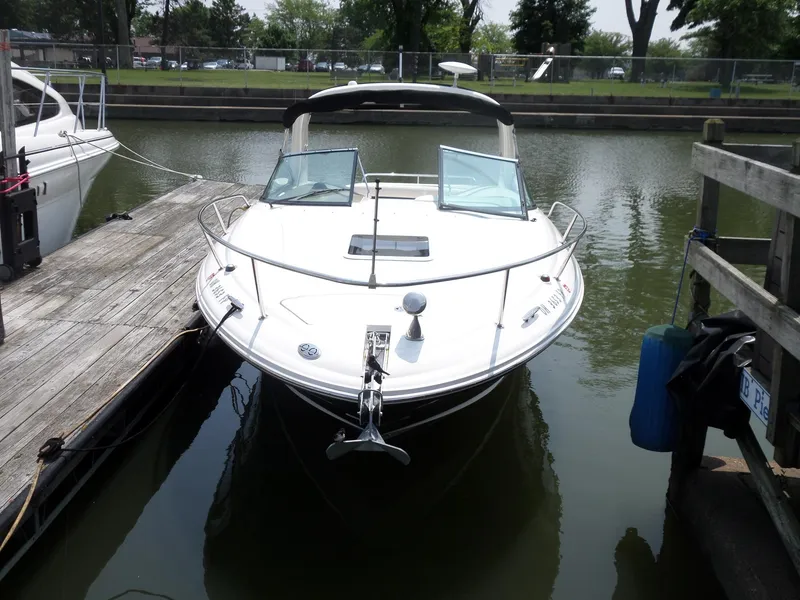Slide: The Image of 2005 Sea Ray 290 SS boat docked in a marina, front view. - 4
