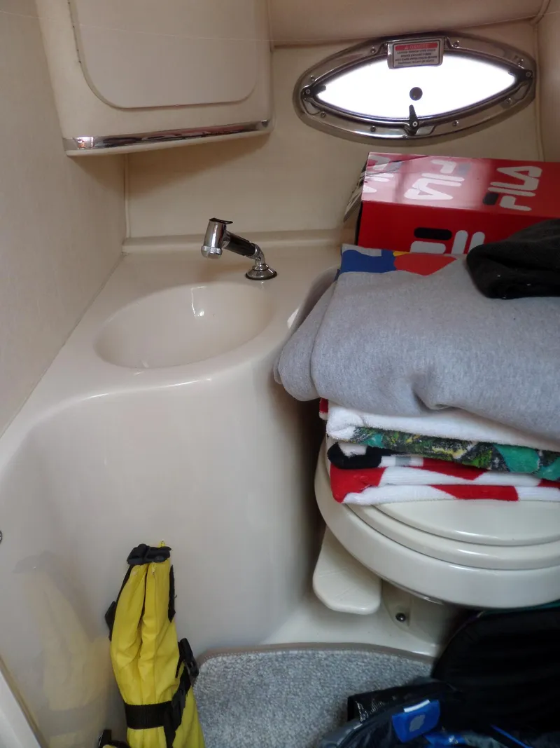 Slide: The Image of 2005 Sea Ray 290 SS cabin with sink, porthole, and storage area. - 40