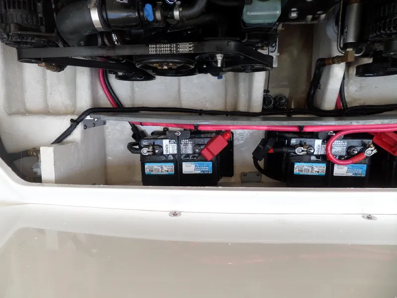 Slide: The Image of Engine compartment of a 2005 Sea Ray 290 SS with visible batteries and wiring. - 46