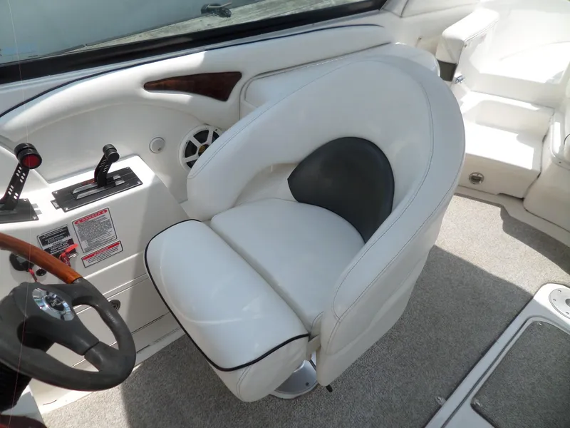 Slide: The Image of Captain's seat and controls of a 2005 Sea Ray 290 SS boat. - 48