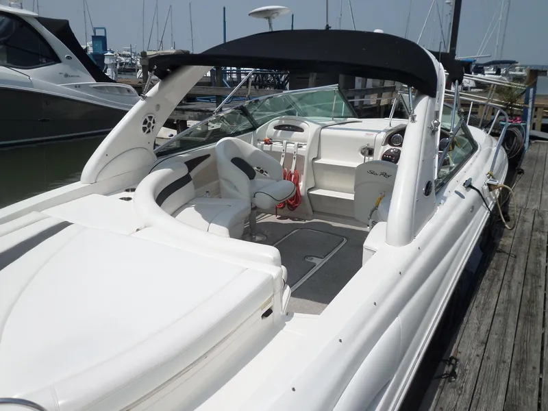 Slide: The Image of 2005 Sea Ray 290 SS boat docked, featuring spacious seating and sleek design. - 6