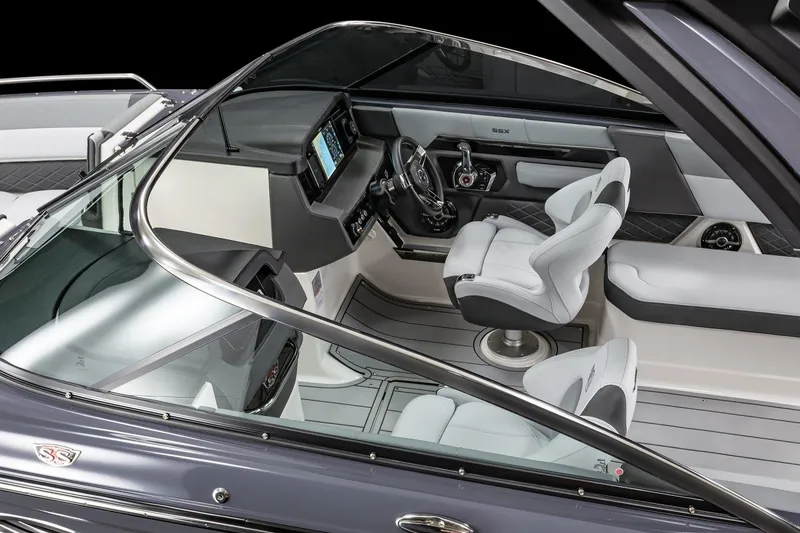 Slide: The Image of 2025 Chaparral 2870 boat interior with modern dashboard and seating. - 17