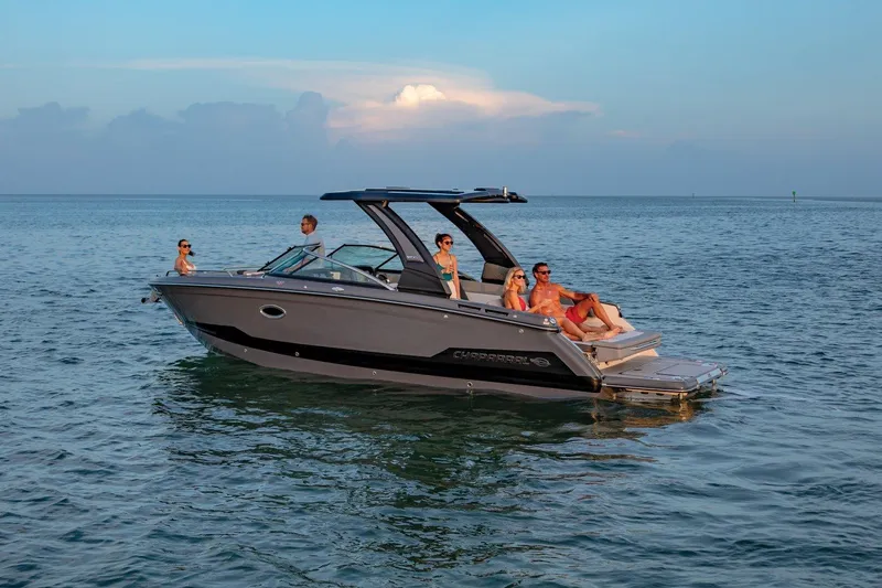 Slide: The Image of 2025 Chaparral 2870 boat with people relaxing on calm ocean waters. - 2