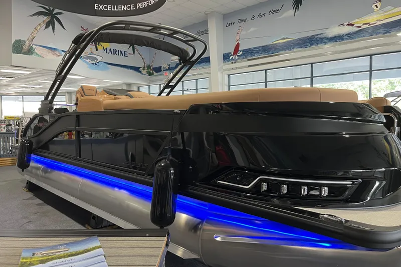 The Image of 2026 Harris Grand Mariner 250 pontoon boat with sleek design and blue LED lighting. - 0