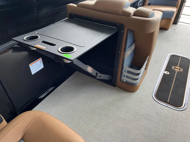Slide: The Image of 2026 Harris Grand Mariner 250 interior with fold-out table and cup holders. - 11
