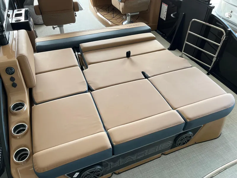 Slide: The Image of 2026 Harris Grand Mariner 250 boat interior with tan cushioned seating and cup holders. - 13