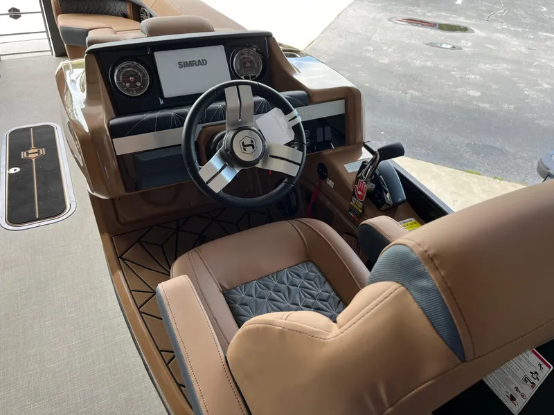 Slide: The Image of 2026 Harris Grand Mariner 250 boat interior with steering wheel and dashboard. - 16