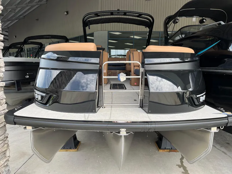 Slide: The Image of 2026 Harris Grand Mariner 250 pontoon boat with sleek black exterior and tan seating. - 5