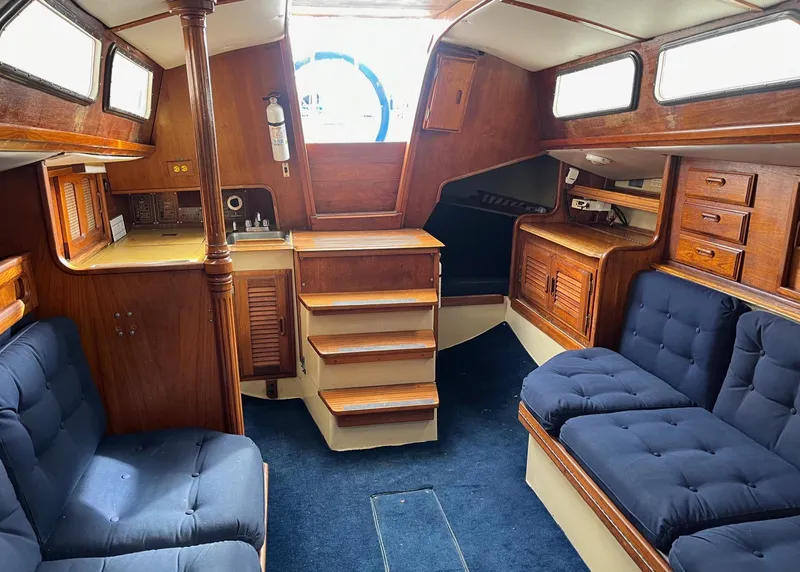 Slide: The Image of Cozy cabin interior of 1978 Islander Sloop 36 sailboat with wooden accents. - 11