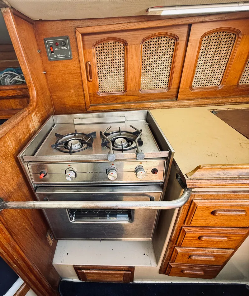Slide: The Image of 1978 Islander Sloop 36 yacht bathroom with wooden cabinetry and compact design. - 13