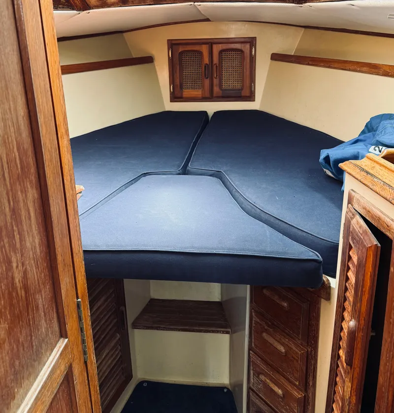 Slide: The Image of 1978 Islander Sloop 36 docked at marina with blue sail cover. - 18