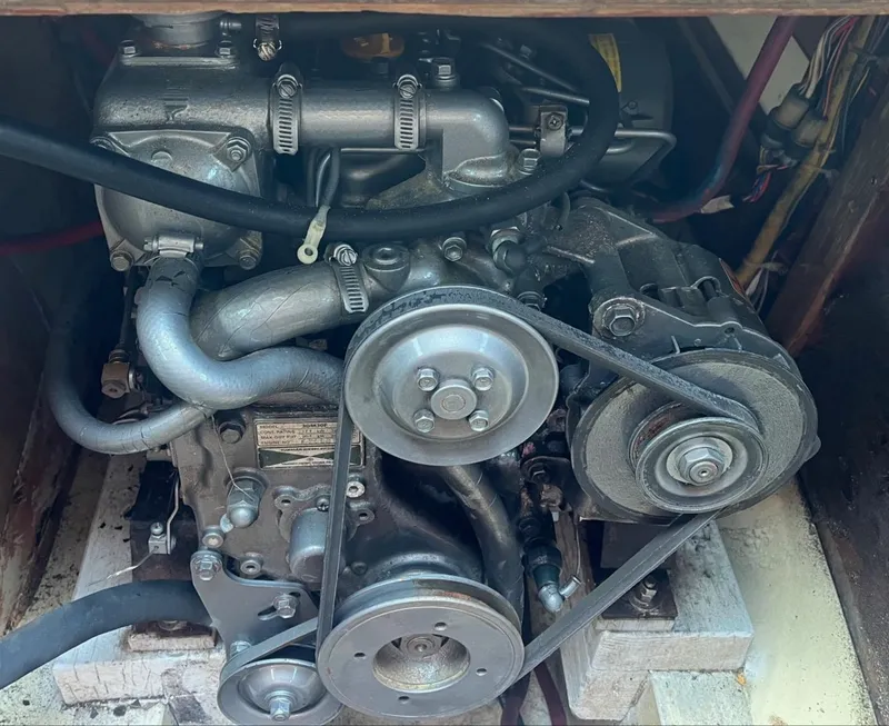 Slide: The Image of Engine of a 1978 Islander Sloop 36 sailboat, featuring belts and hoses. - 21