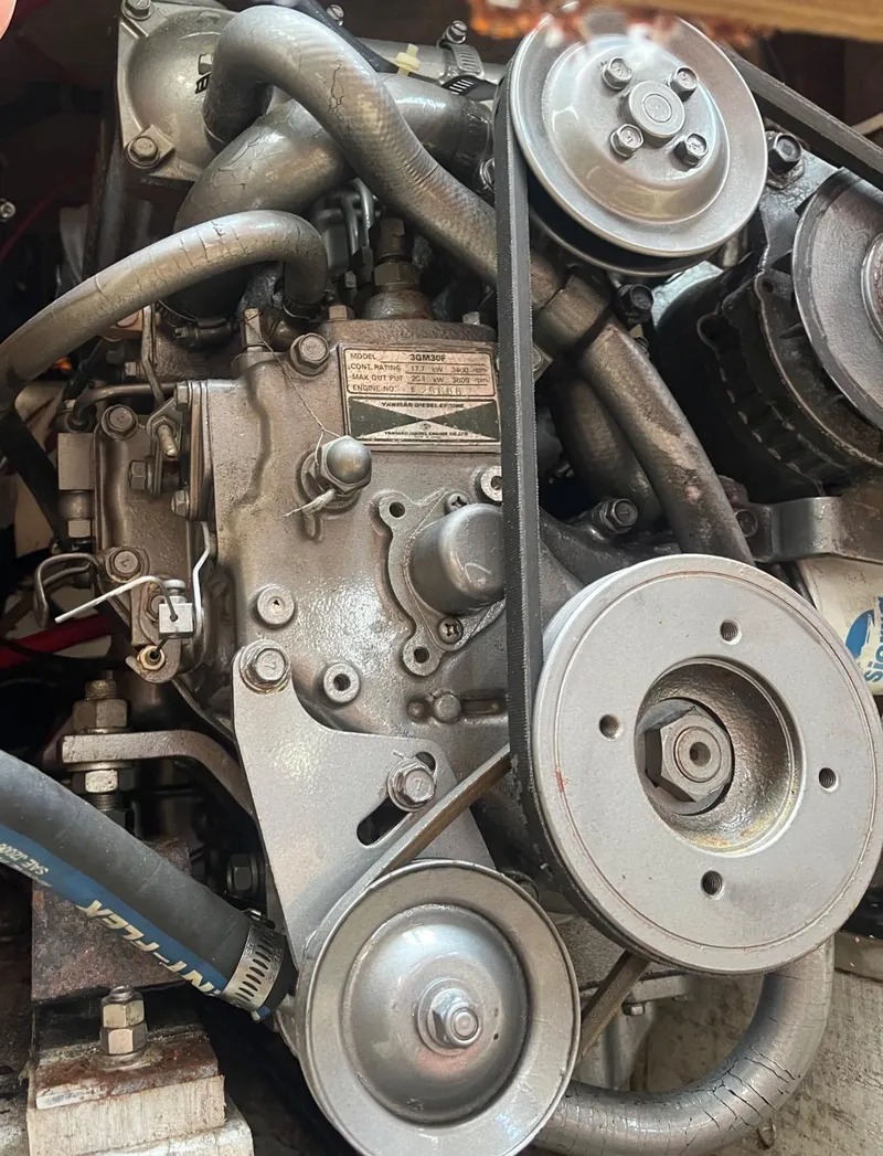 Slide: The Image of Engine of a 1978 Islander Sloop 36 sailboat, featuring belts and pulleys. - 22