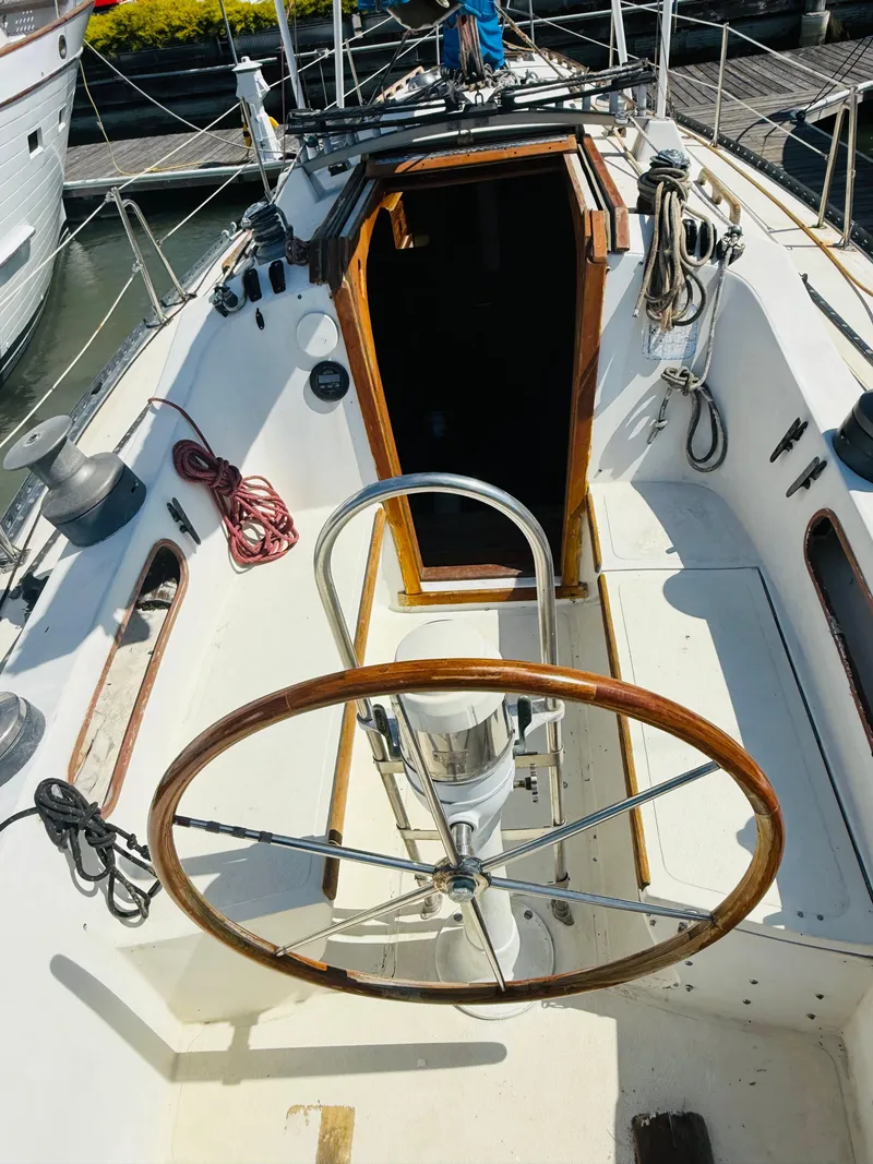 Slide: The Image of Interior of 1978 Islander Sloop 36 sailboat with wooden furnishings and blue upholstery. - 3