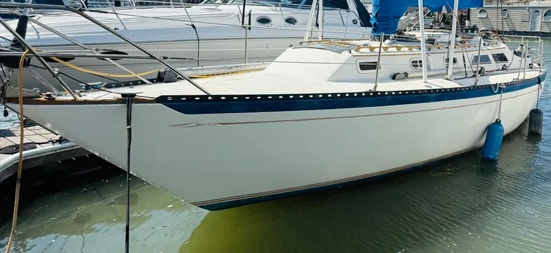 Slide: The Image of Interior of 1978 Islander Sloop 36 sailboat with wooden finishes and blue seating. - 4
