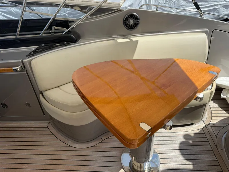 Slide: The Image of 2012 Riva Rivale yacht interior with wooden table and cushioned seating. - 18