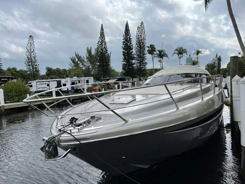 Slide: The Image of Luxury 2012 Riva Rivale yacht docked by palm trees and RVs. - 2