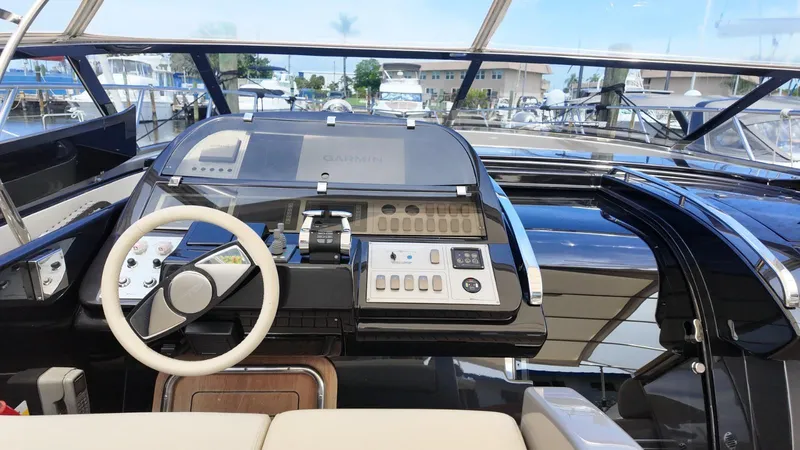 Slide: The Image of Helm of 2012 Riva Rivale yacht with modern controls and Garmin navigation system. - 25