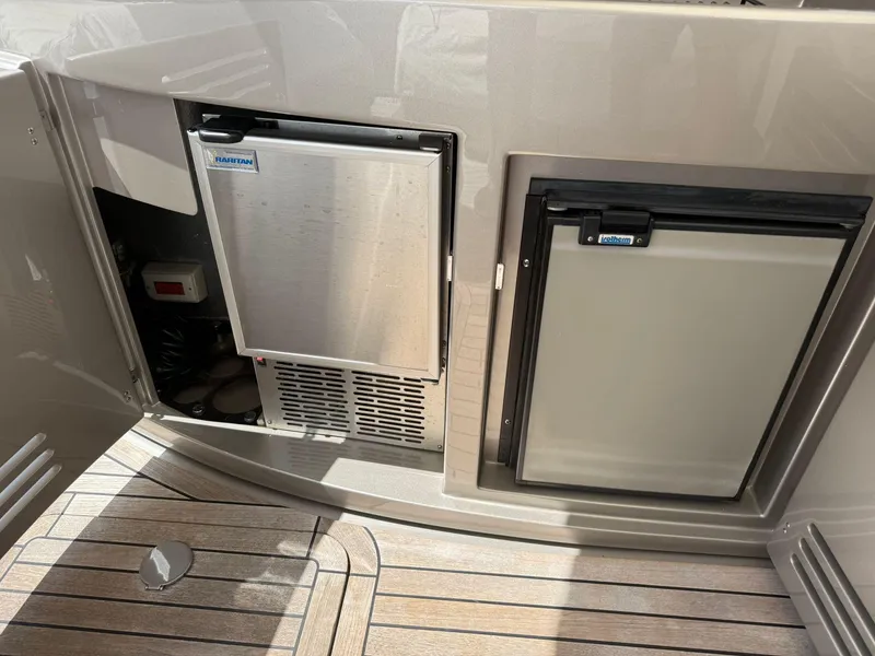 Slide: The Image of 2012 Riva Rivale yacht interior with built-in refrigeration units on teak flooring. - 36