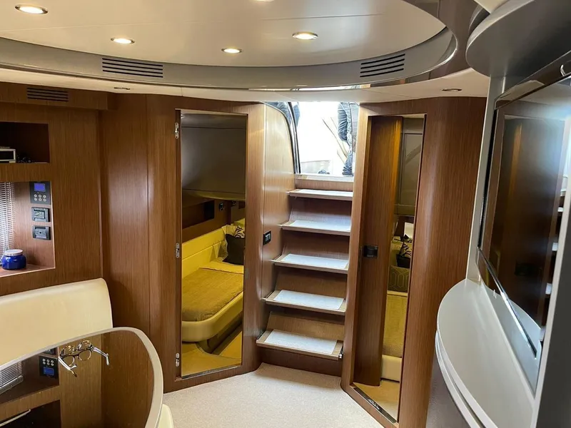 Slide: The Image of Luxurious interior of a 2012 Riva Rivale yacht with modern wood finishes and elegant design. - 40