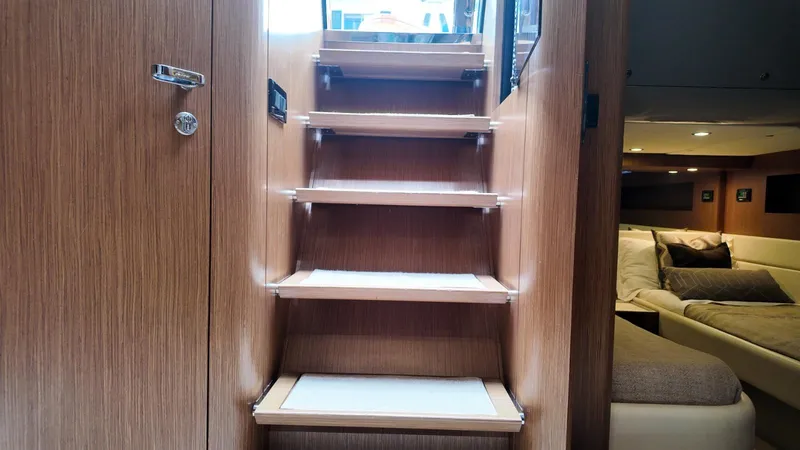 Slide: The Image of Interior of 2012 Riva Rivale yacht featuring wooden stairs and cozy seating area. - 41