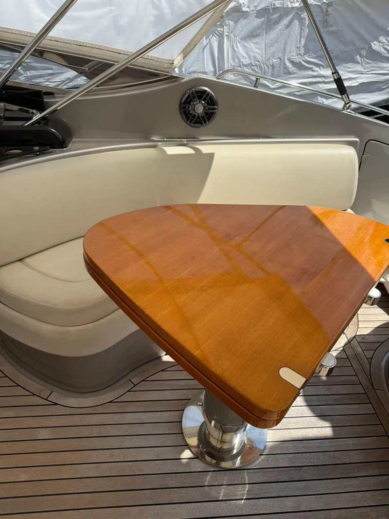 Slide: The Image of Luxurious 2012 Riva Rivale yacht interior with elegant wood table and cushioned seating. - 44